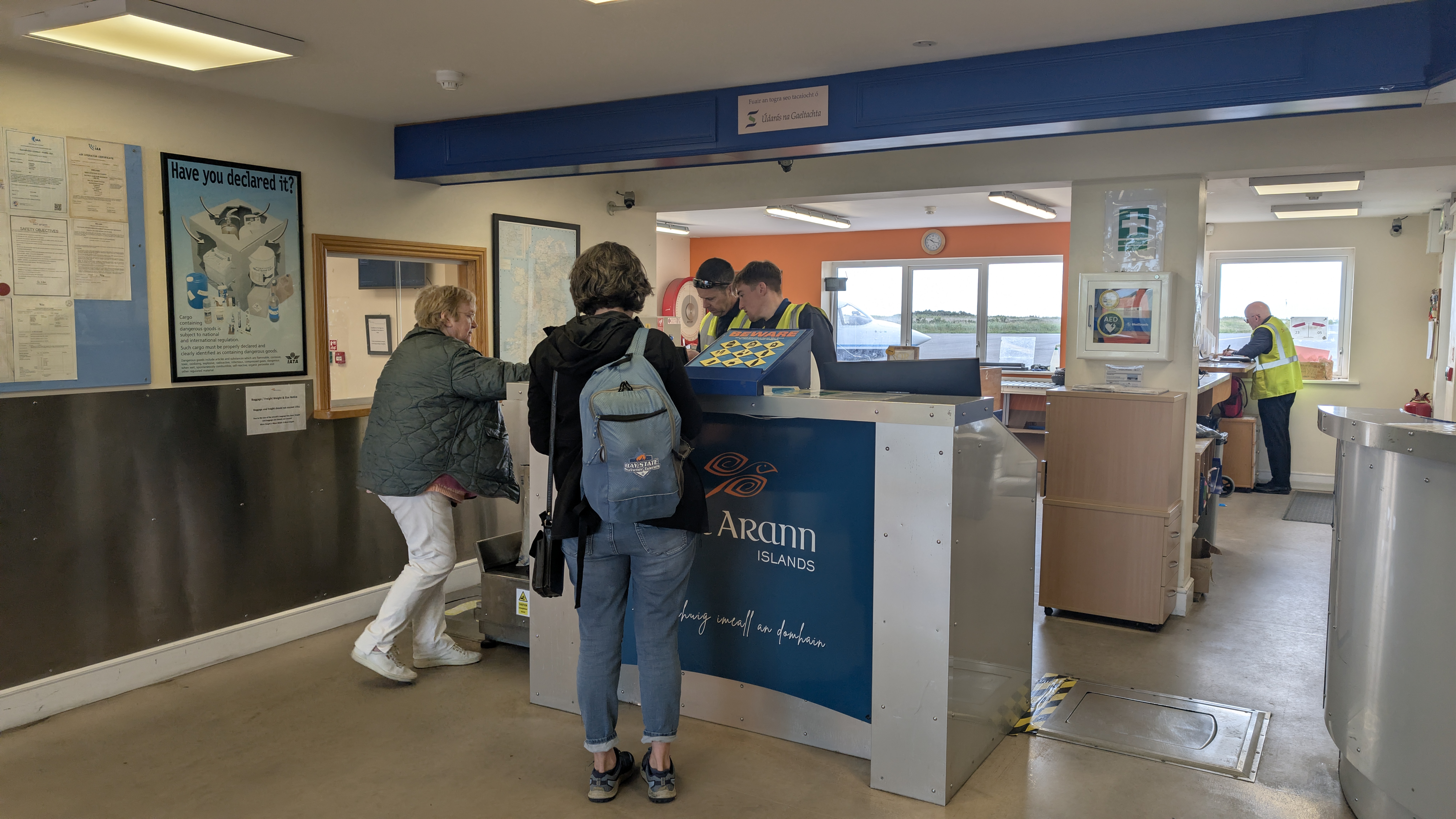 Passengers checking in at the Aer Arann Islands desk at Connemara Airport, where staff now see live bookings, waitlists, and paid services in Farel.