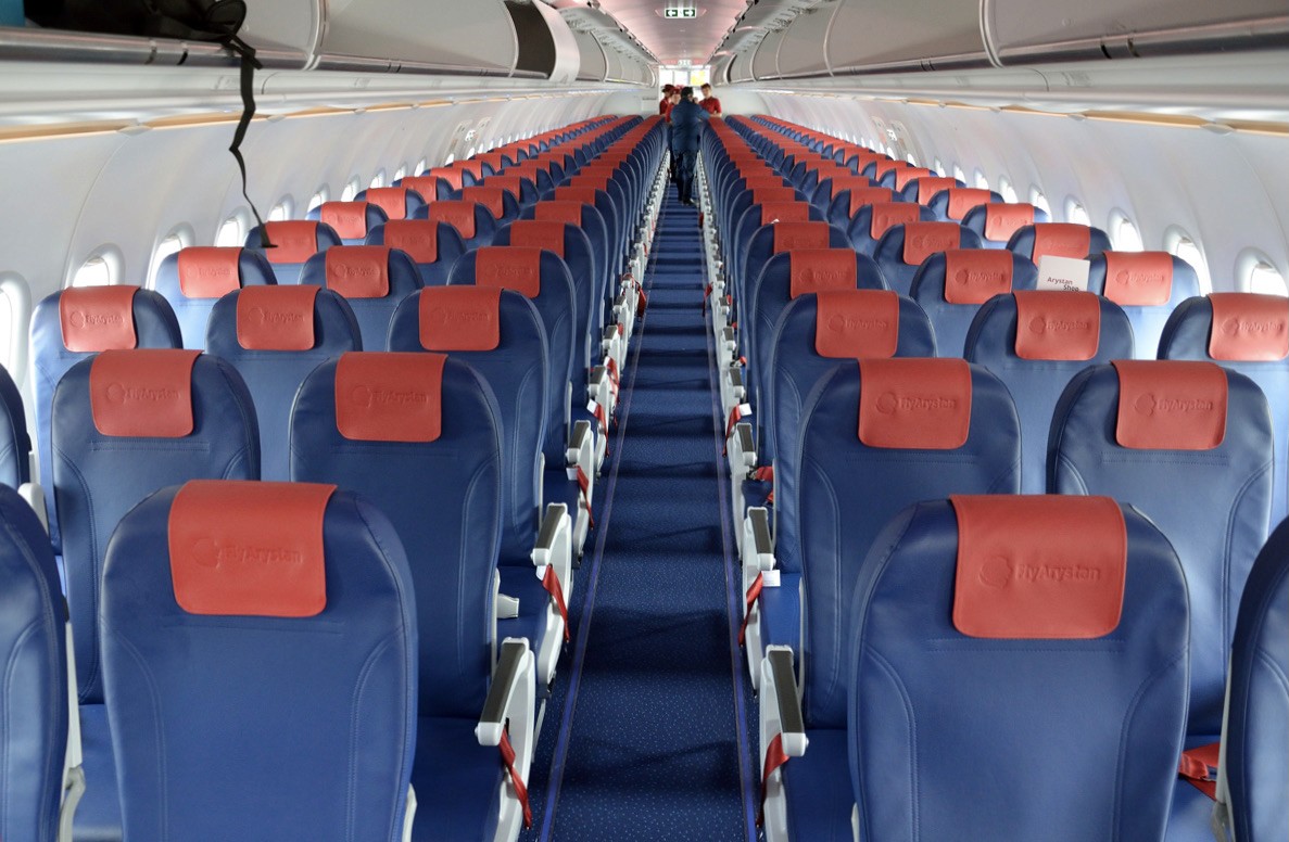 Empty cabin of a FlyArystan A320 with blue and orange leather seats