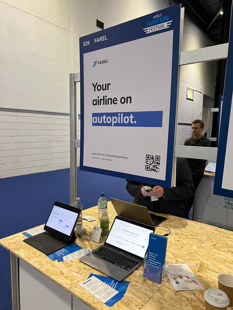 Farel booth S39 at World Aviation Festival 2021 with "Your airline on autopilot" signage and demo laptops