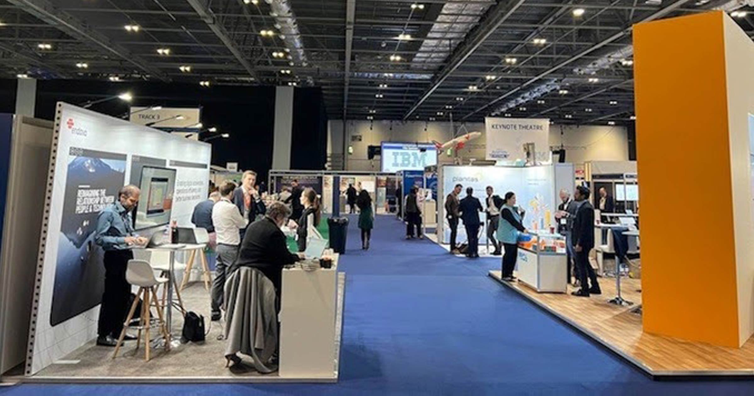 Exhibition floor at ExCel London during World Aviation Festival 2021 with vendor booths and attendees